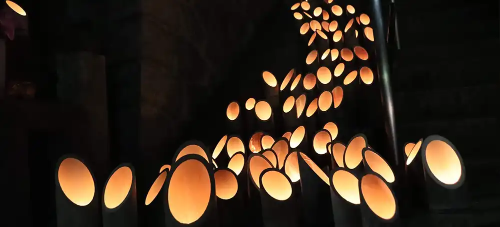 Bamboo lanterns lit in the temple grounds